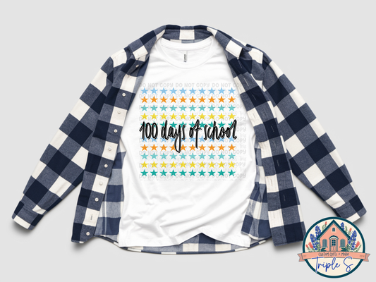 White t-shirt with '100 days of school' design under a blue and white checkered shirt on a light gray background.